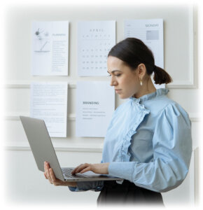 pexels-woman-standing-with-laptop-research-planning-121