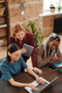 three-women-working-together-research-planning-123