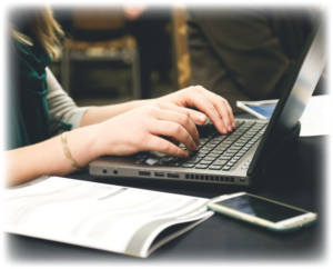 person-typing-with-journal-proposal-development-43